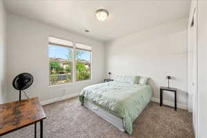 Carpeted bedroom with baseboards