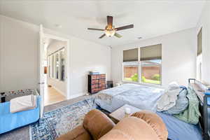 Bedroom featuring carpet floors, a ceiling fan, and baseboards