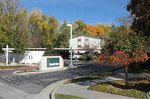 View of asphalt road featuring sidewalks and curbs