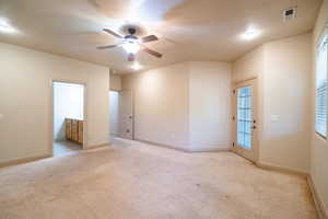 Unfurnished room with light carpet, a ceiling fan, and baseboards