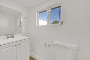 Half bathroom with toilet and vanity