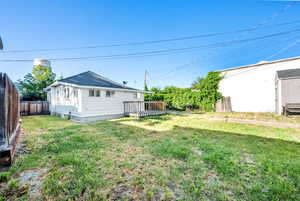 Fenced backyard featuring a deck