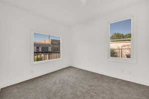 Unfurnished room with carpet and baseboards