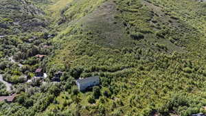 View of property location featuring a forest