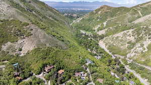 Aerial view of property and surrounding area with a mountainous background