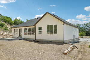Back of property featuring entry steps and stucco siding