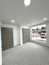 Unfurnished bedroom with carpet flooring, recessed lighting, baseboards, and a closet
