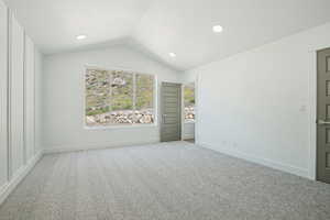 Unfurnished bedroom featuring vaulted ceiling, carpet flooring, baseboards, and recessed lighting