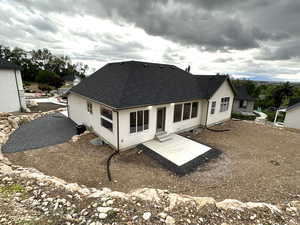 Rear view of property with roof with shingles, a patio area, stucco siding, and entry steps