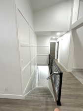 Stairway featuring baseboards and wood finished floors