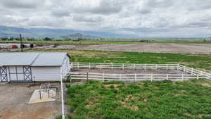 View of yard featuring a view of rural / pastoral area, an outdoor structure, a mountain view, and an exterior structure