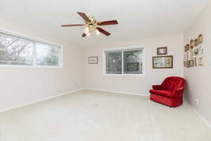 Unfurnished room featuring carpet floors, ceiling fan, and baseboards