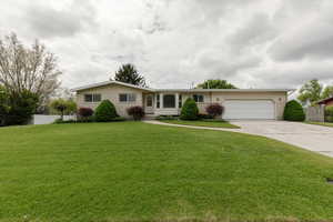 Ranch-style home with driveway, an attached garage, and brick siding