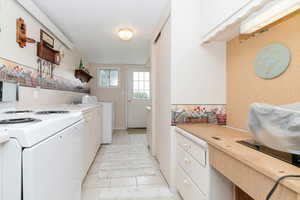 Washroom featuring light tile patterned flooring and a textured ceiling