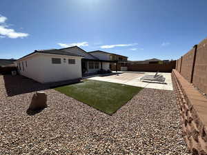 Rear view of property with a patio and a fenced backyard