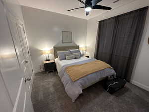 Carpeted bedroom featuring baseboards and a ceiling fan