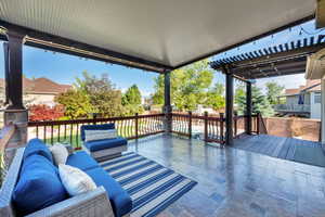 Wooden terrace featuring outdoor lounge area and a pergola