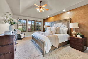 Bedroom with baseboards, a tray ceiling, recessed lighting, ceiling fan, and carpet floors