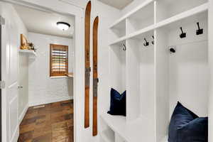 Mudroom with wallpapered walls, baseboards, and stone finish floors