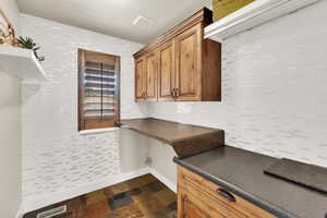 Washroom with baseboards and dark stone finish floors