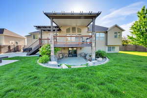 Rear view of property with french doors, a patio area, a wooden deck, stairway, and a pergola