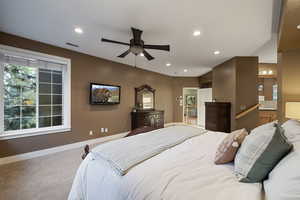 Primary bedroom with baseboards, recessed lighting, and carpet