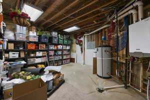 Unfinished below grade area featuring gas water heater and electric panel