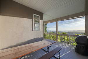 Deck featuring area for grilling, valley and mountain views, and outdoor dining space