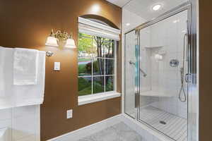Primary full bath with a stall shower, baseboards, and recessed lighting