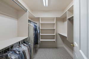 Walk in closet featuring carpet floors