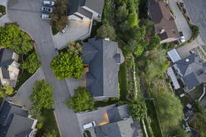Aerial view of property and surrounding area featuring nearby suburban area
