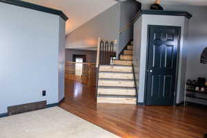 Stairway featuring baseboards and wood finished floors