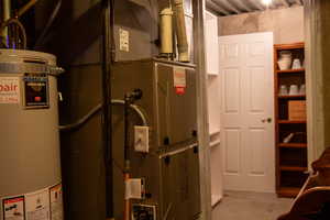 Utility room with water heater, furnace, storage