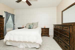 Bedroom with light colored carpet and ceiling fan