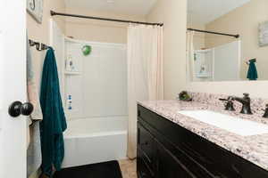 Full bath featuring vanity and shower / tub combo