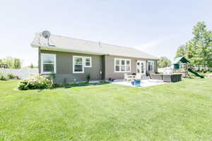 Back of property featuring a patio, a playground, an outdoor hangout area, and french doors