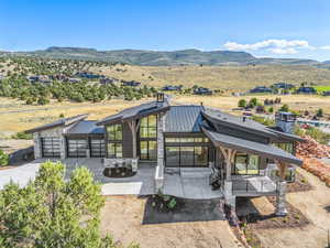 Front of house featuring concrete driveway, a mountain view, a garage, metal roof, and a standing seam roof
