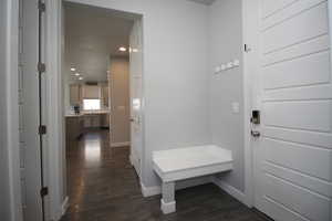 Mudroom featuring LVP floors, baseboards, recessed lighting, and a bench