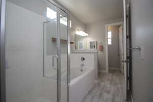 Primary bathroom with a stall shower, a bath