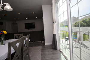 Dining room with baseboards, LVP floors, and recessed lighting