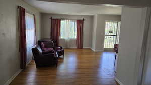 Sitting room with wood finished floors and baseboards