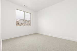 Unfurnished room with carpet and baseboards