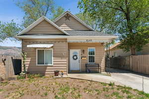 View of front of house featuring roof with shingles and a porch