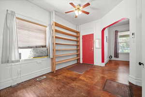 Foyer with a ceiling fan, baseboards, and wood finished floors