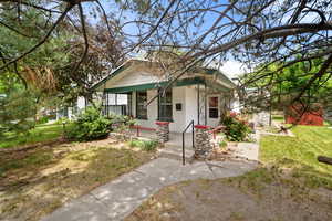 View of front of property with a porch and brick siding