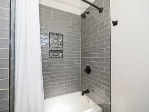 Full bath featuring shower / bathtub combination with curtain