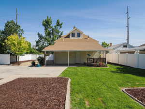 Rear view of property with concrete driveway, roof with shingles, and a chimney
