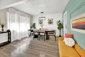 Dining area with wood finished floors and a textured ceiling