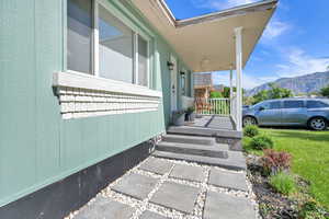 Entrance to property featuring a mountain view and covered porch