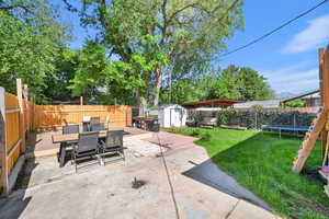 View of patio with outdoor dining space and a trampoline